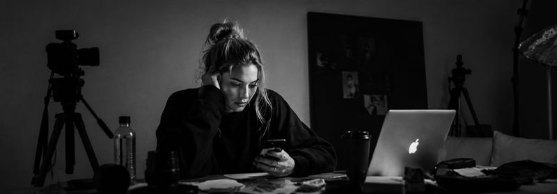Creator working alone at a desk with camera equipment